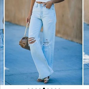 NWOT.  Vici London High rise flare jeans with rips.  Size 7/27, never worn.